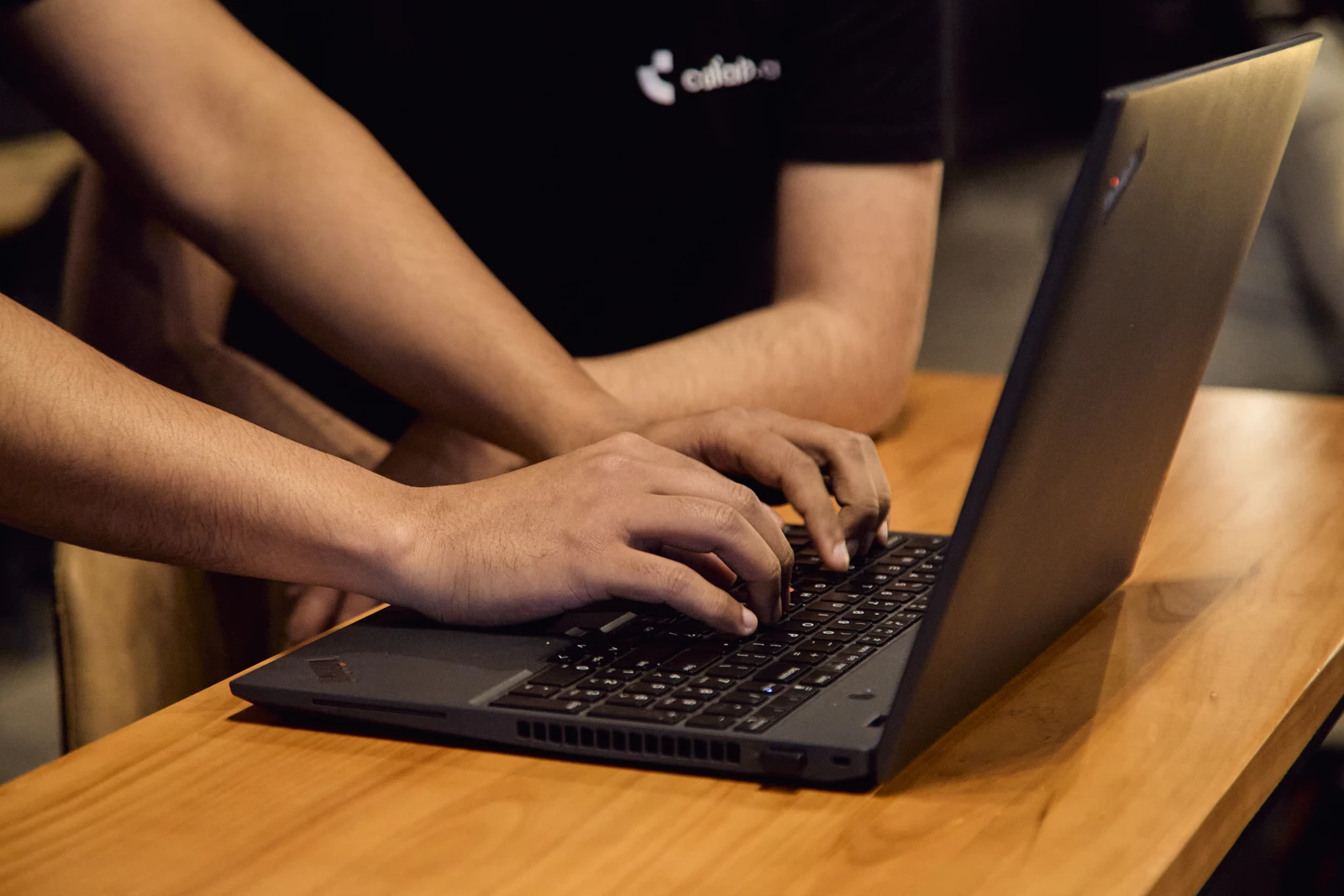 A Calab.ai engineer working on a laptop