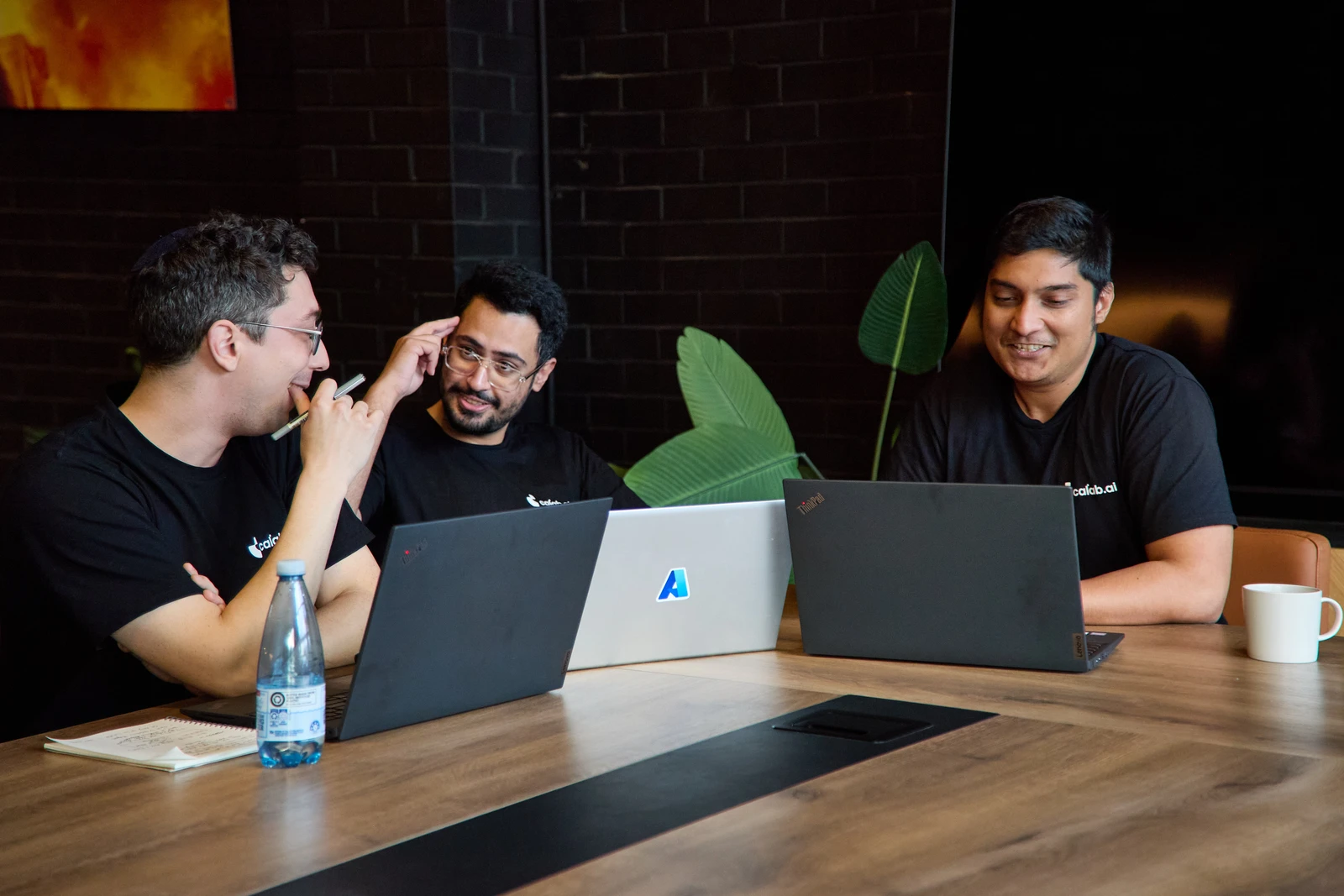 Calab.ai colleagues reviewing their work together at a laptop