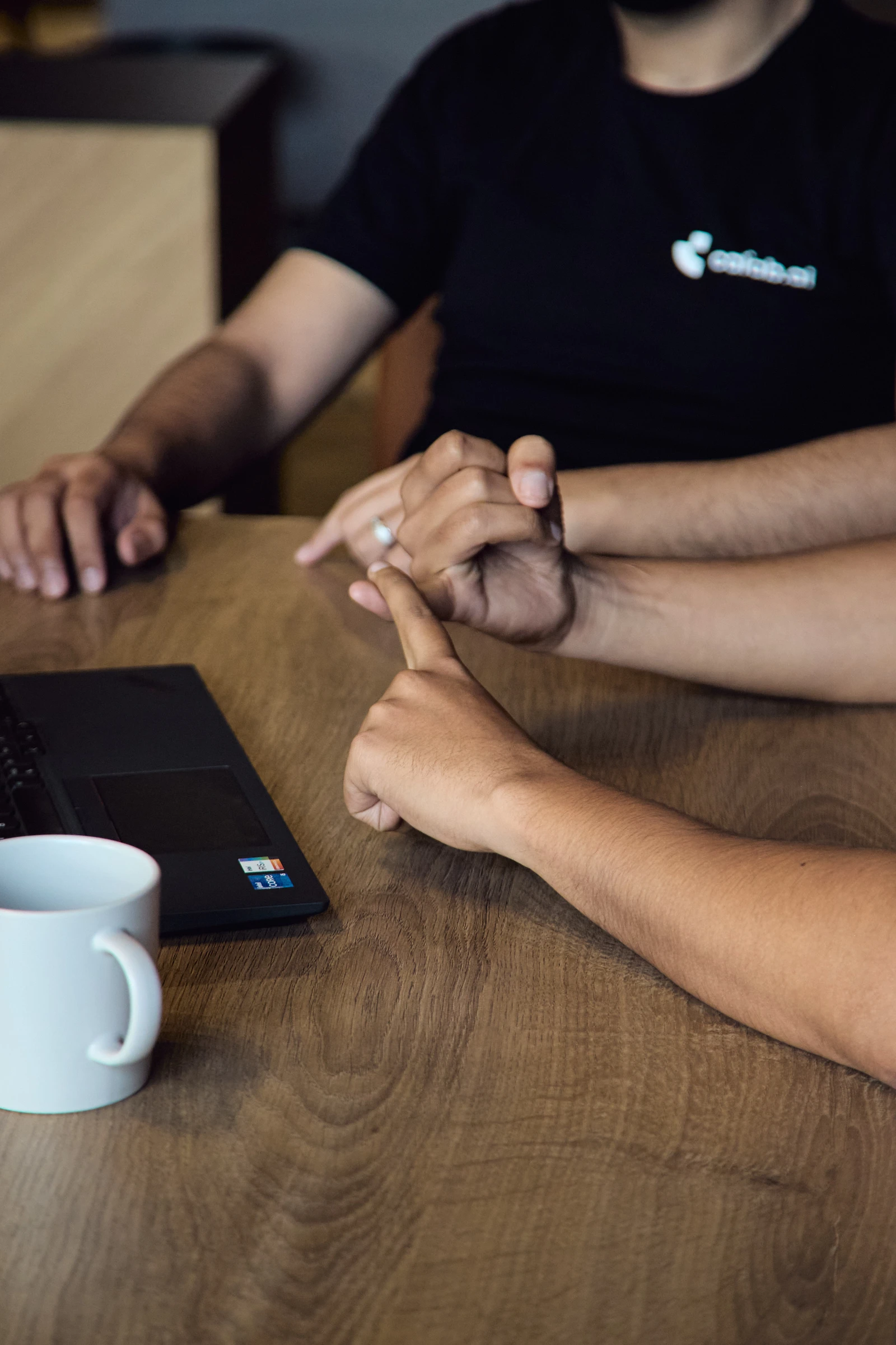 Calab.ai colleagues discussing a process around a table