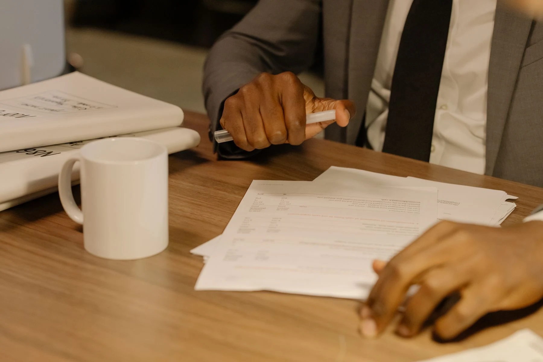 Hands reviewing a document and making notes