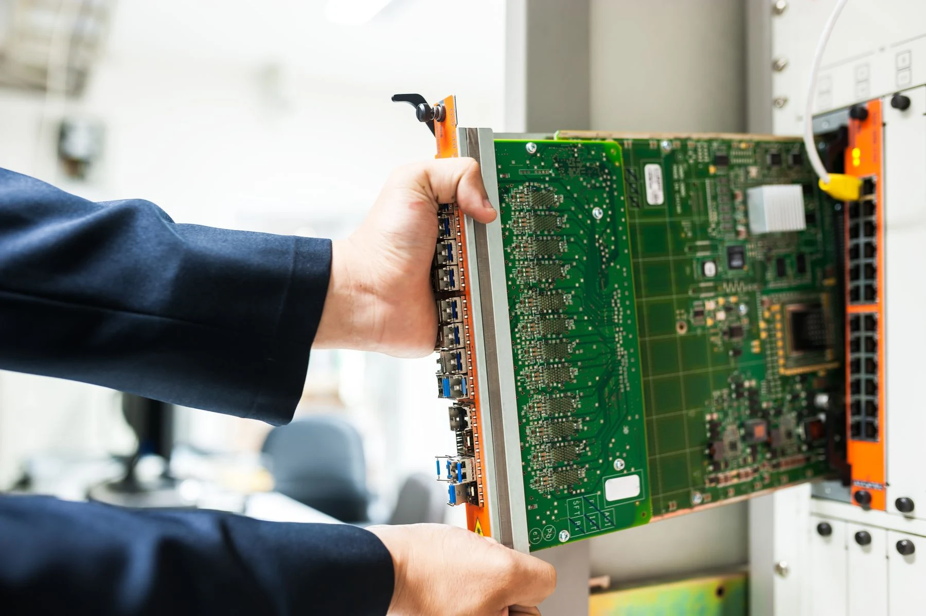 A technician working with equipment in a network rack