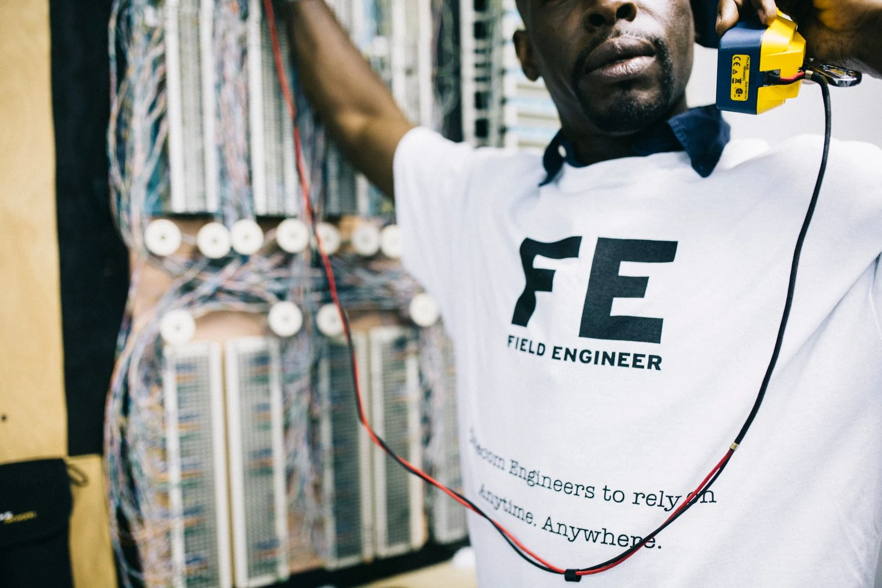 A field engineer checking network connections with test equipment