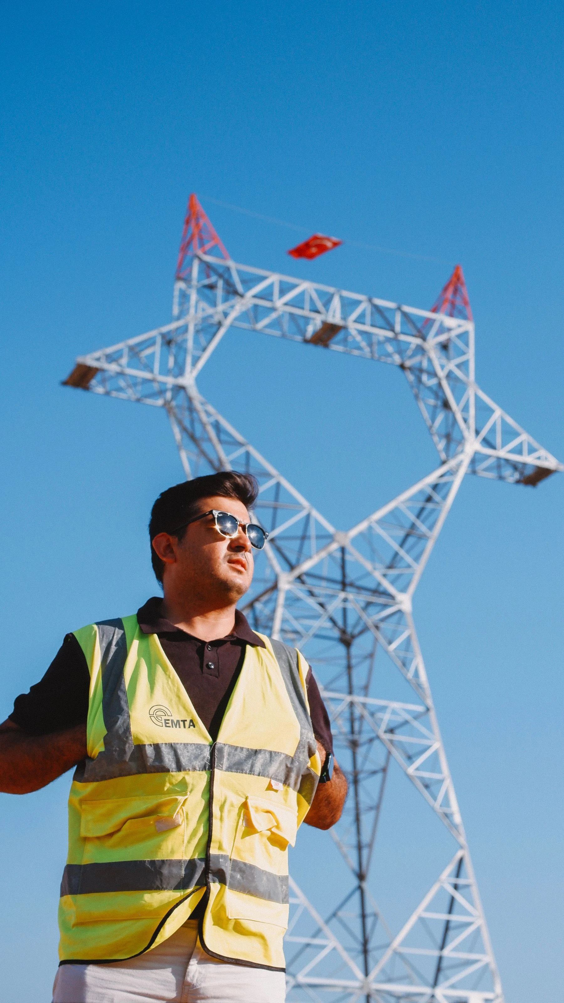 An engineer inspecting a power transmission tower