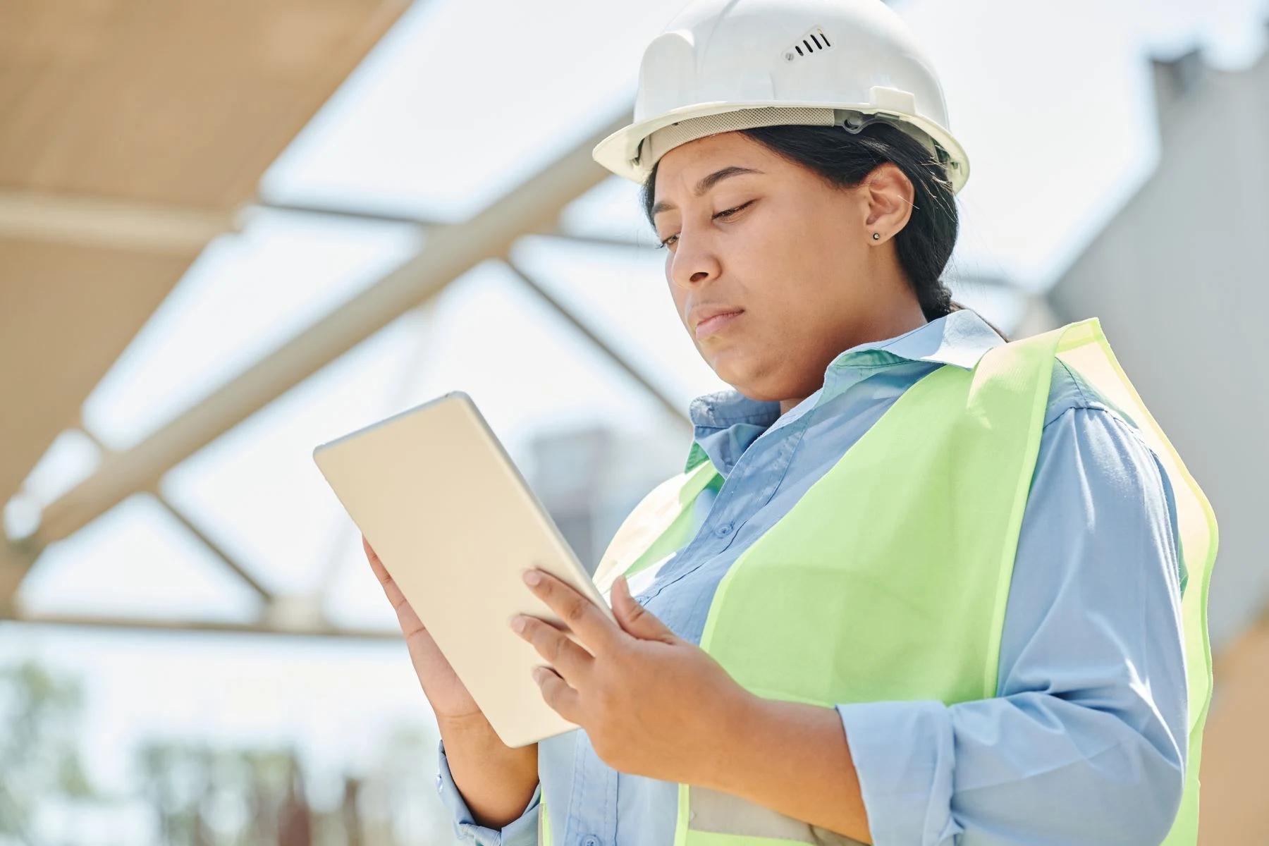A field engineer checking a digital tablet on site